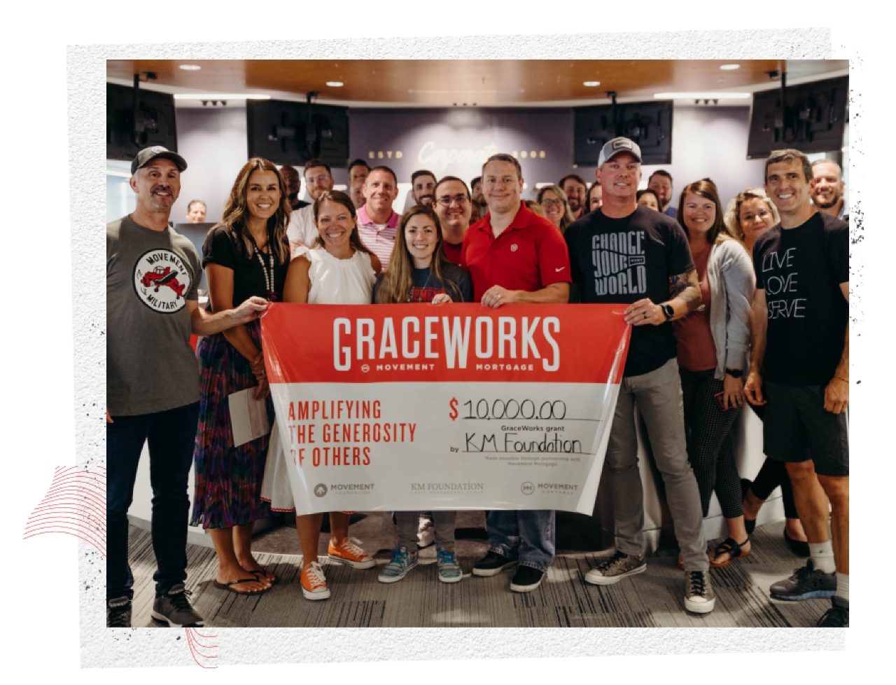Group of people smiling holding a banner with a grant for GraceWorks