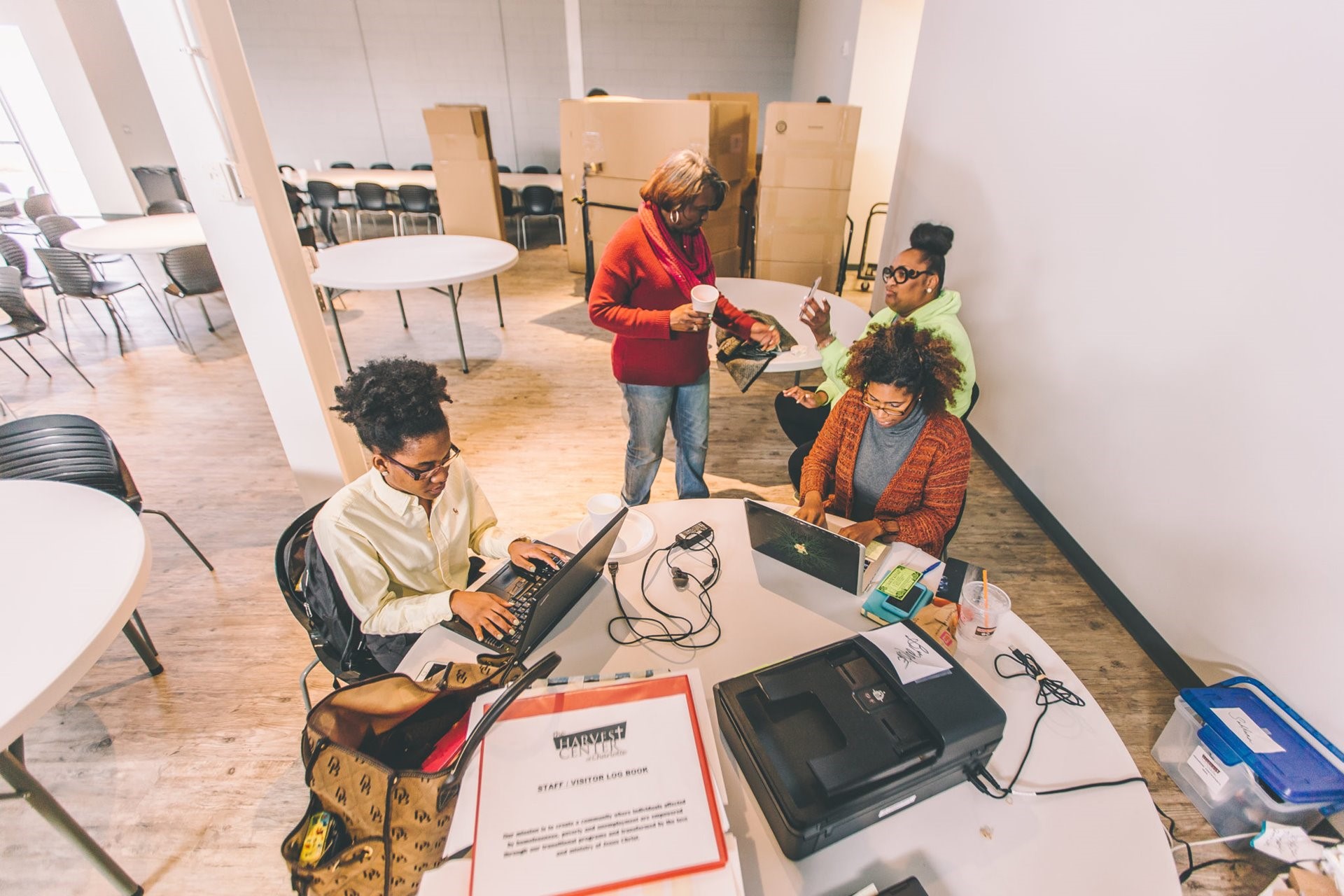 Volunteers help prepare the Harvest Center for its grand opening at the Movement Center.