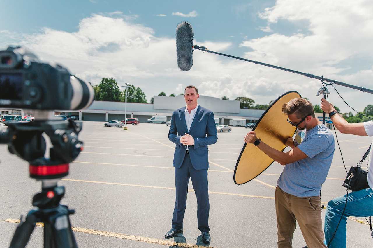 Movement Creative Director Joe Little (at right) jumps in to lend a hand during a video shoot.