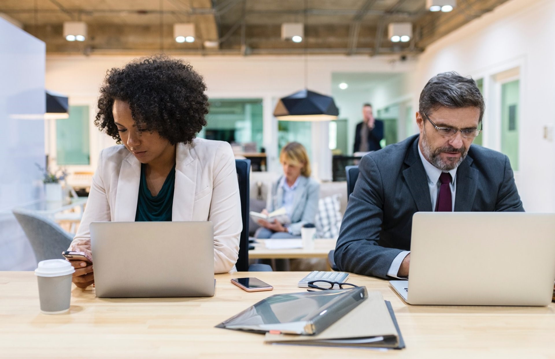 Two people working on their laptop