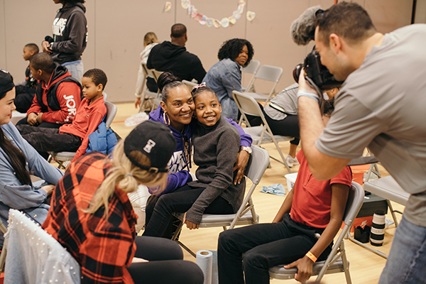 Gloria James hugs a Movement school child. 