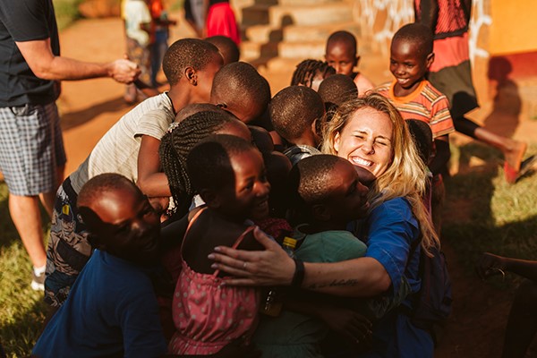 Movement employee with Ugandan children