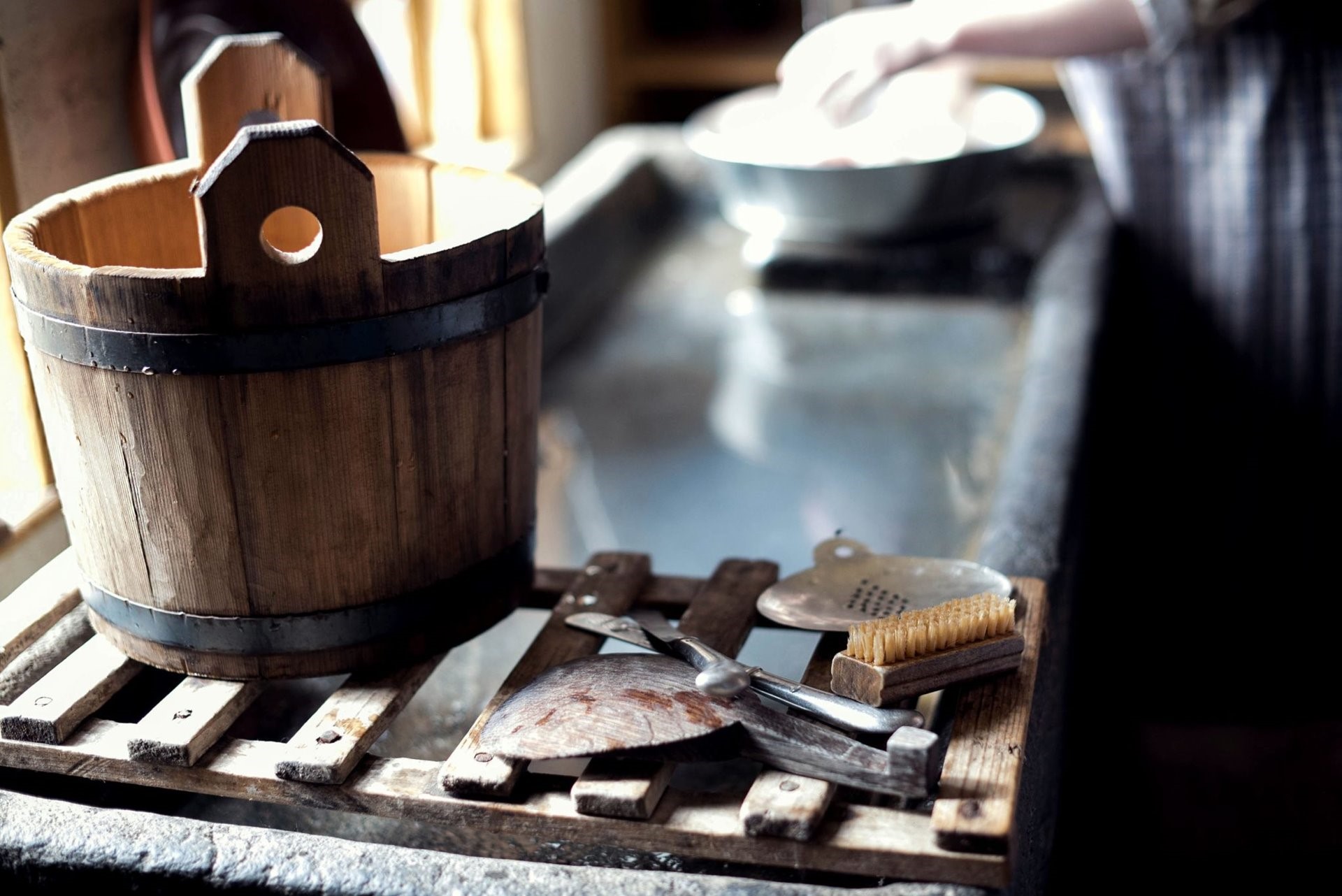 Brown bucket sitting at a sink