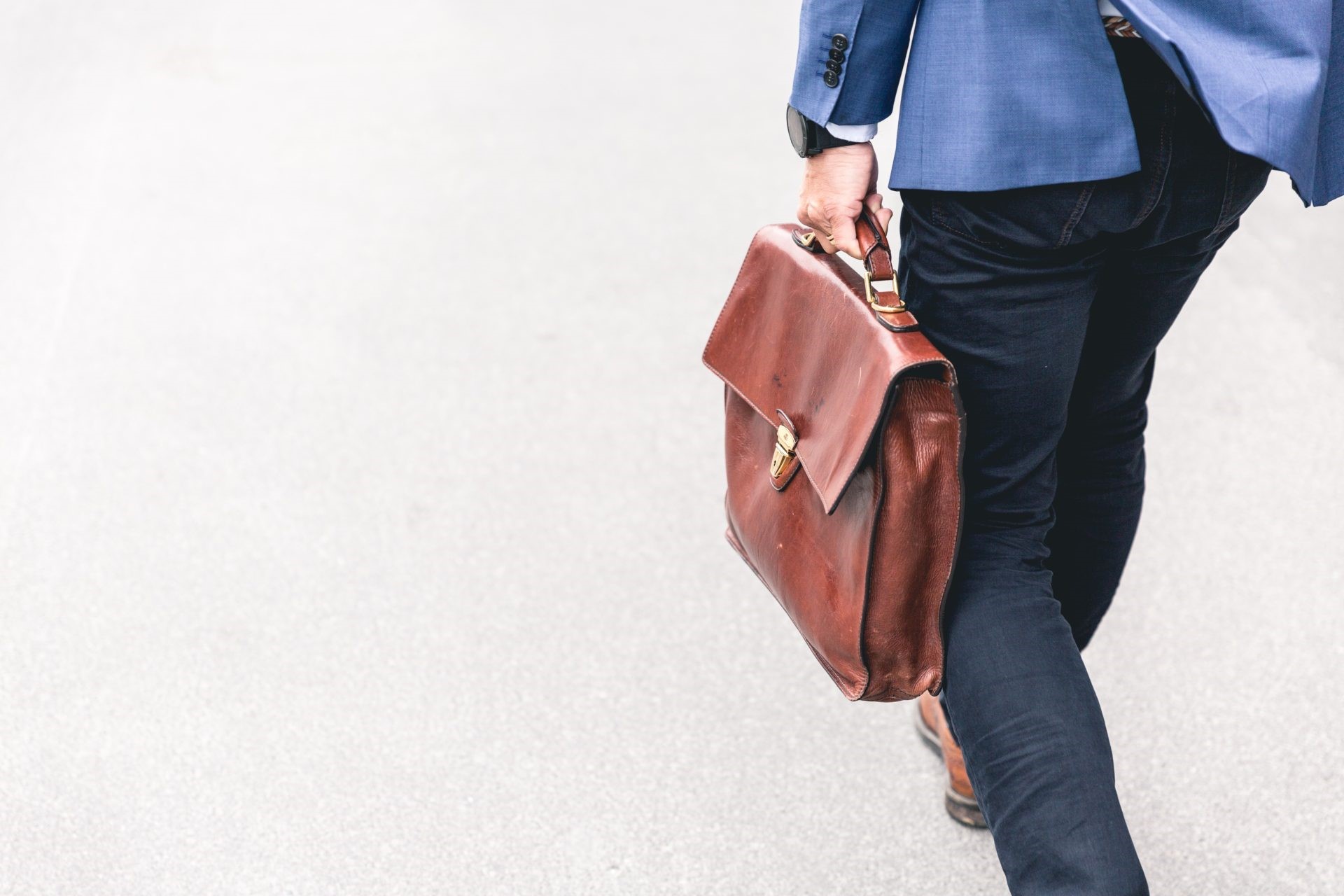 Bottom photo of a man carry a work bag