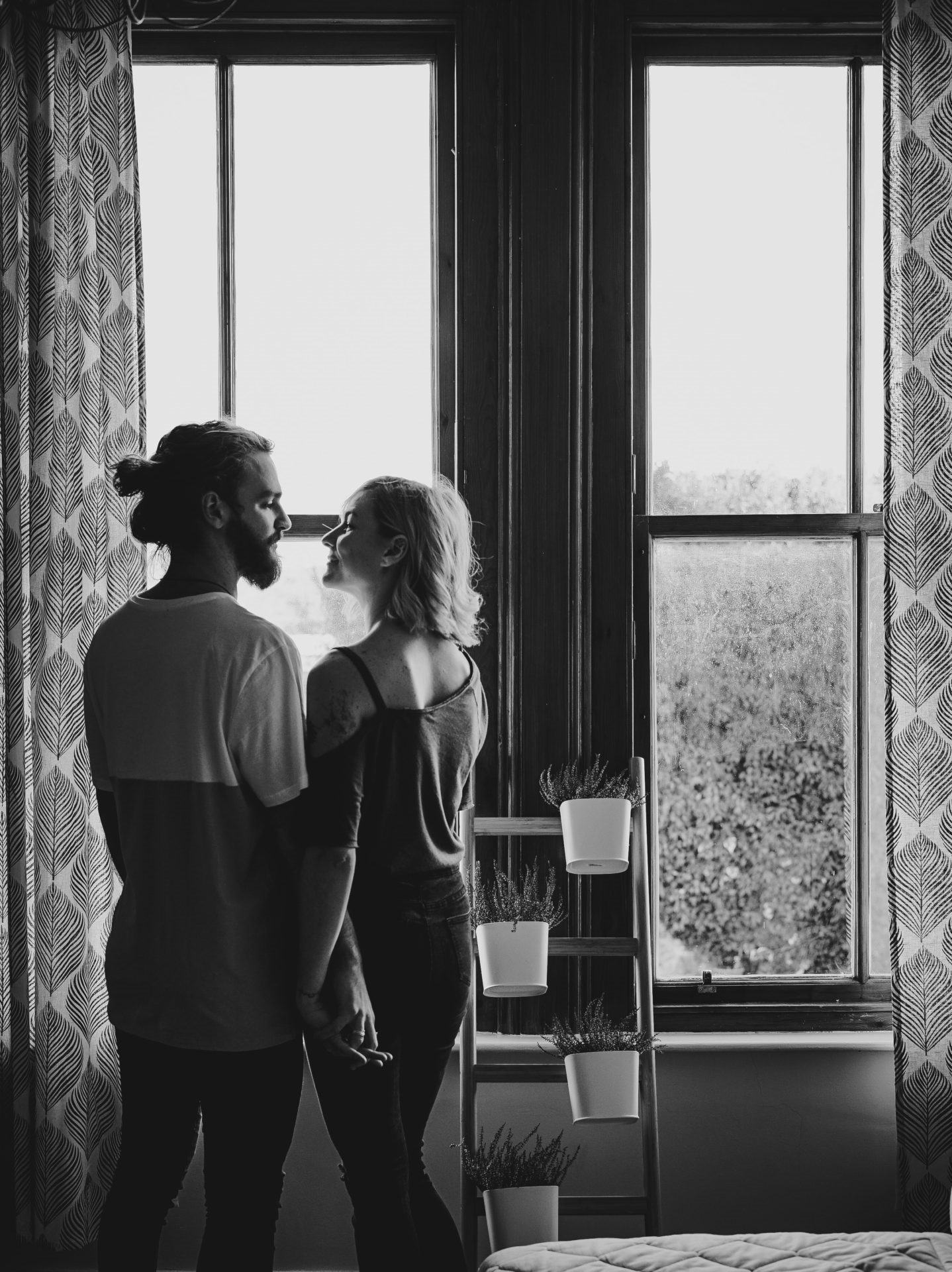 Couple standing by the window