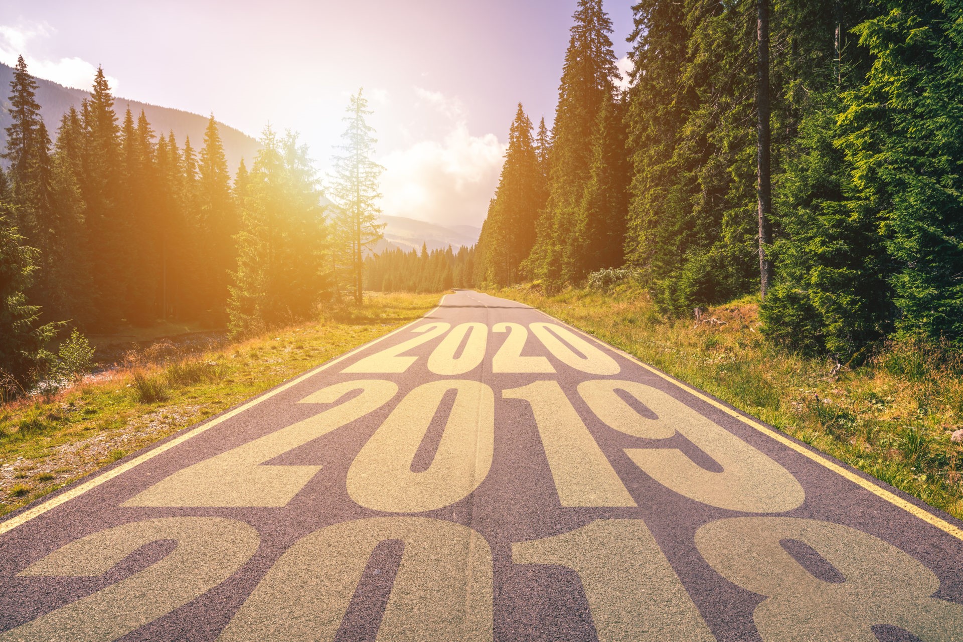 Empty asphalt road and New year 2018, 2019, 2020 concept. Driving on an empty road in the mountains to upcoming 2018, 2019, 2020 and leaving behind old years. Concept for success and passing time.