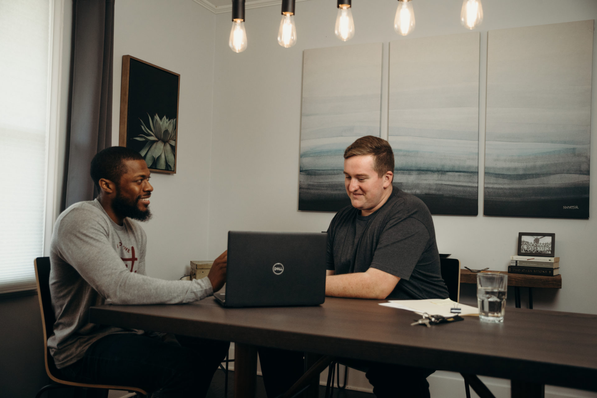 Two guys sitting in kitchen table 