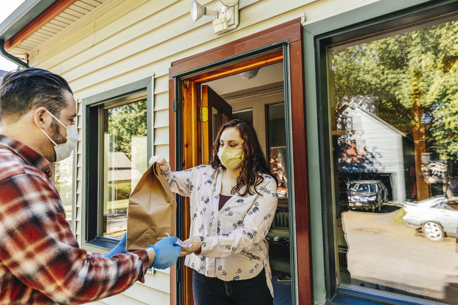 Young woman receives food delivery