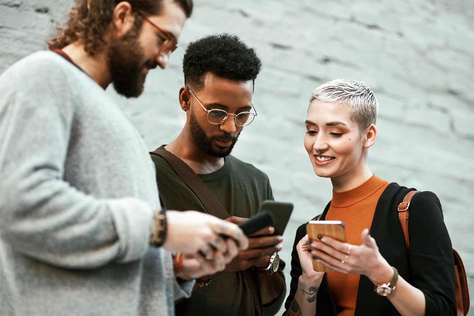 a group of people looking at their phones