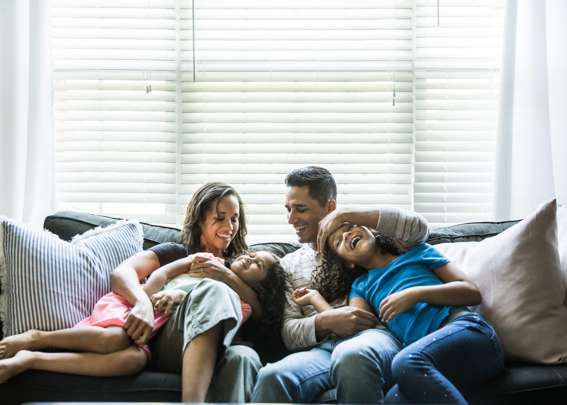 Portrait of young family of sofa at home