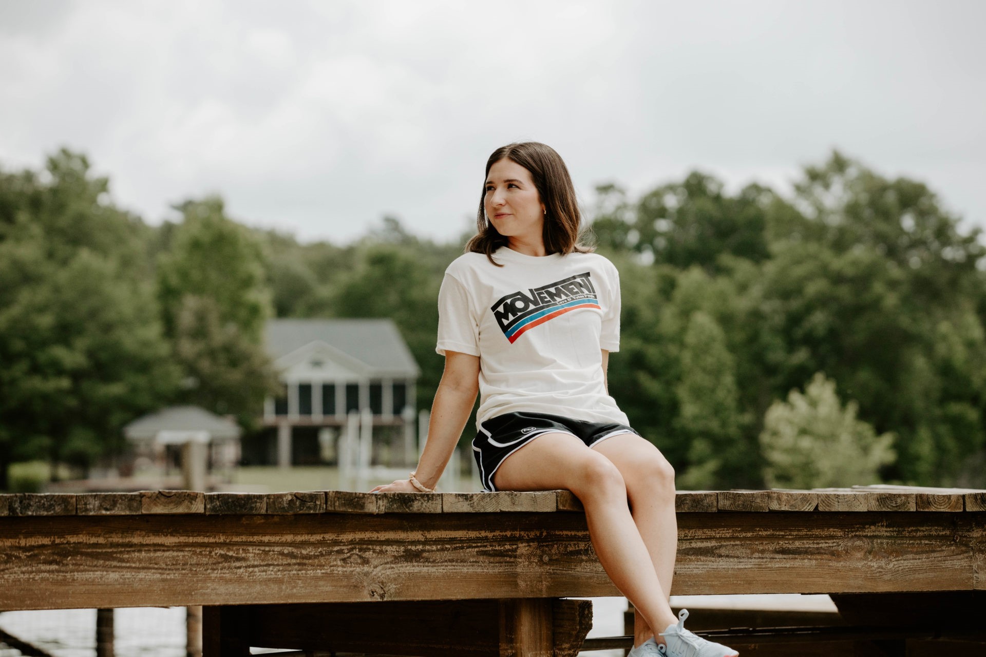 A woman modeling white Movement t-shirt