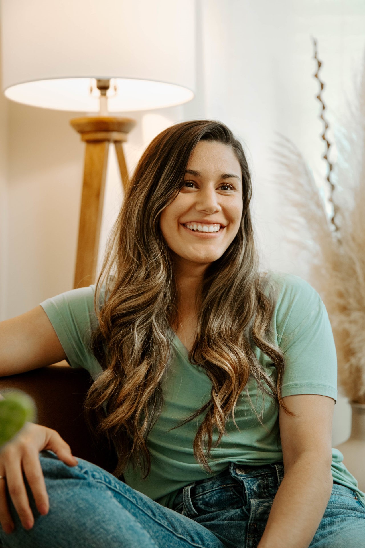 A woman sitting on the couch smiling