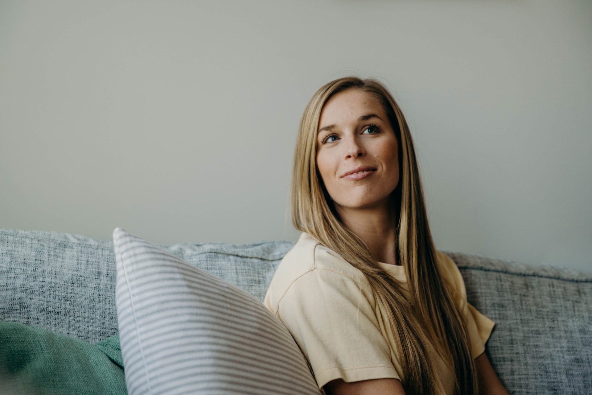 Close up of Blonde woman sitting on the couch