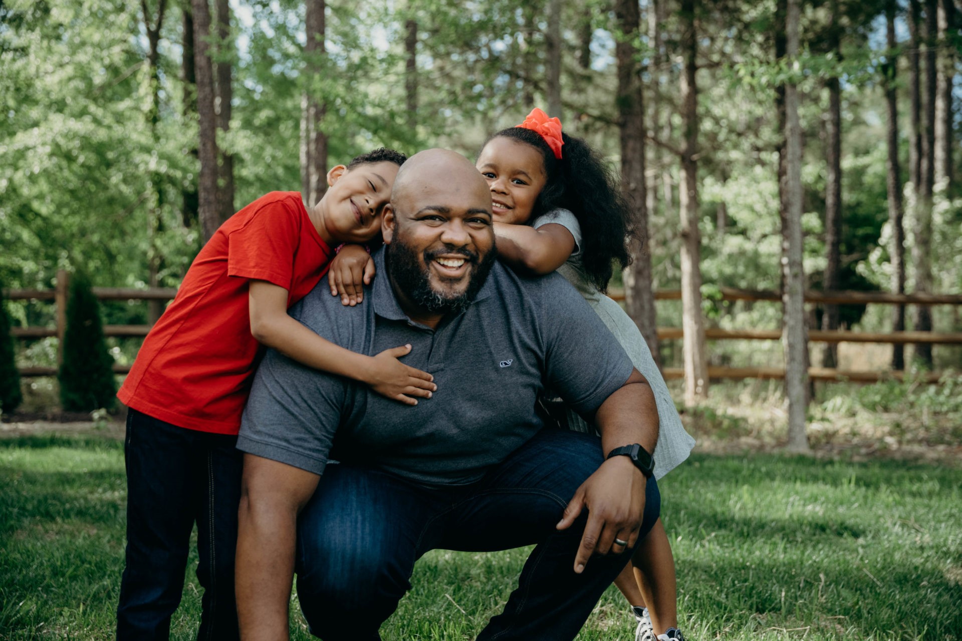 A father and his two kids playing outside