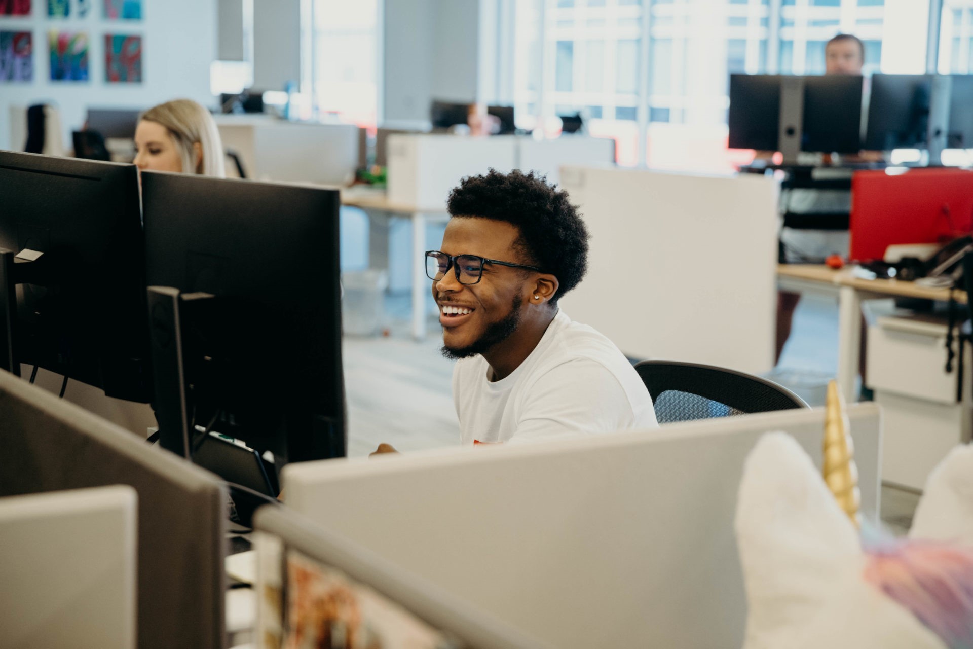 A black male wearing glasses working