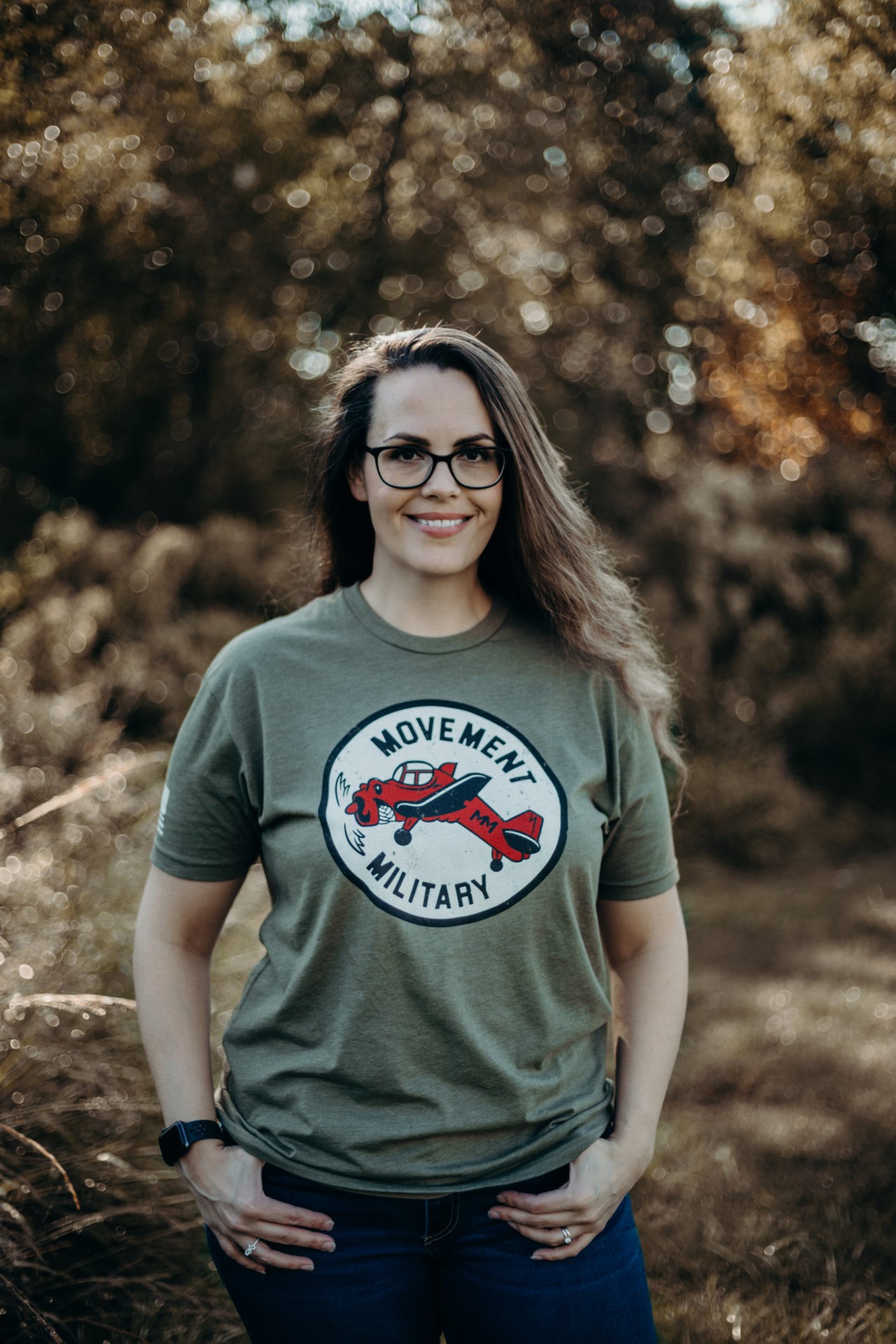 Dark haired woman wearing Movement Military shirt