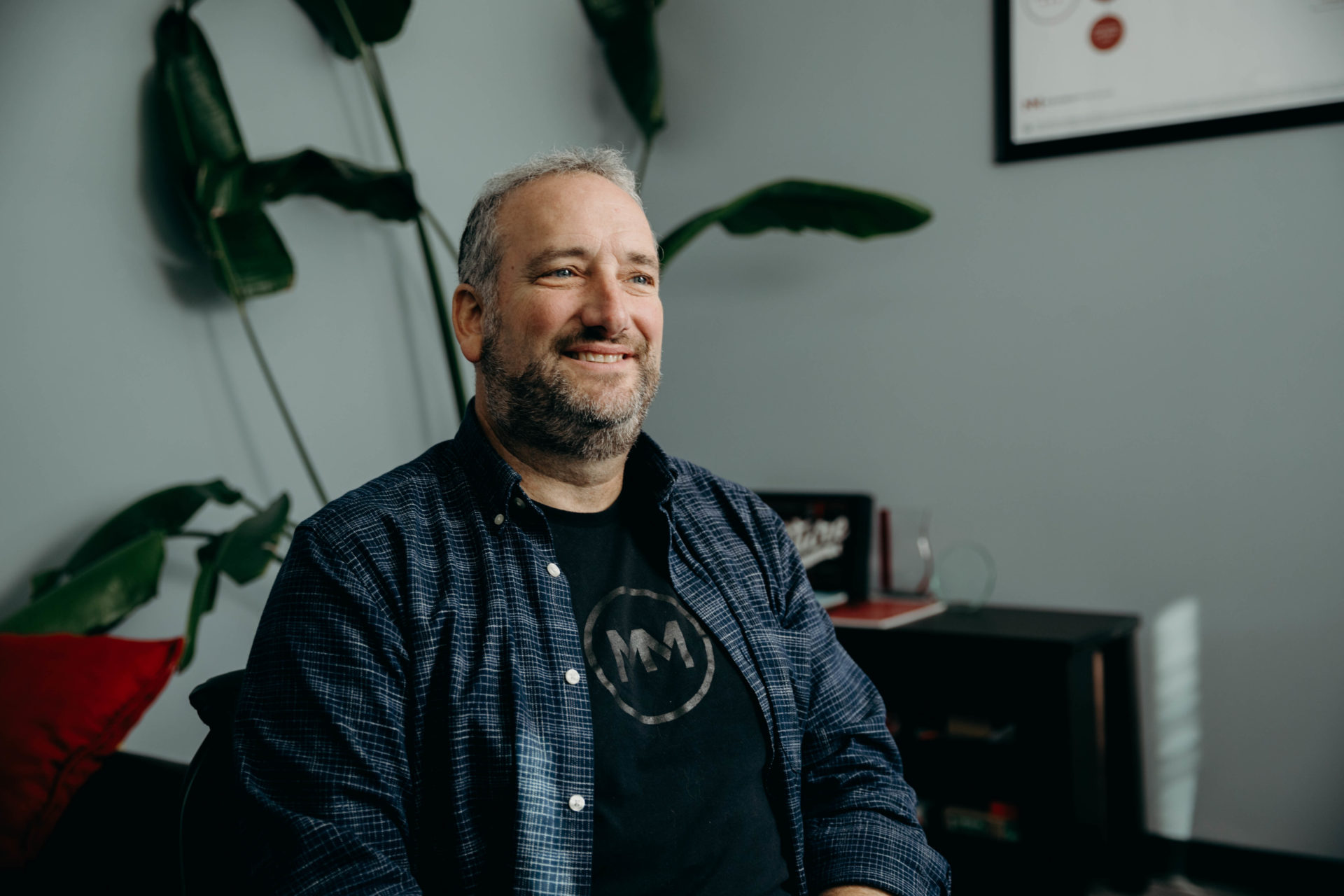 Man wearing MM black shirt sitting down for an interview