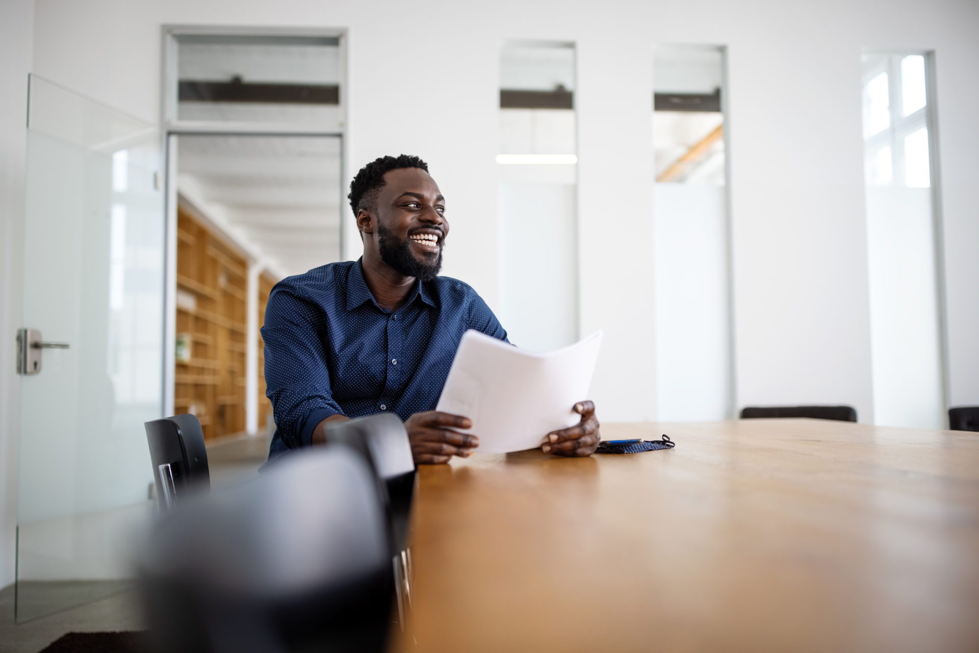 Businessman sitting in conference room and smiling