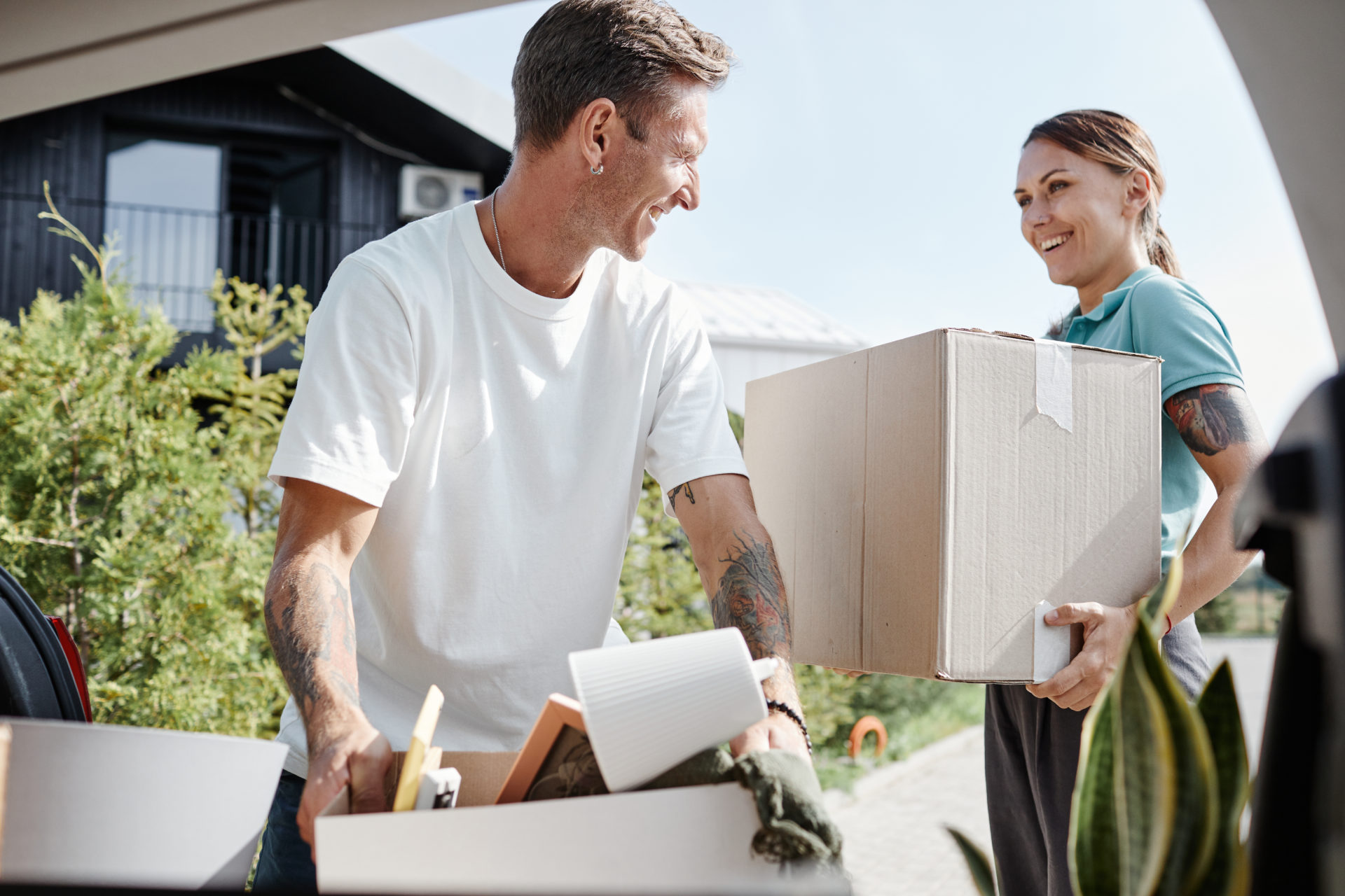 Couple Loading Boxes to Car in Sunlight