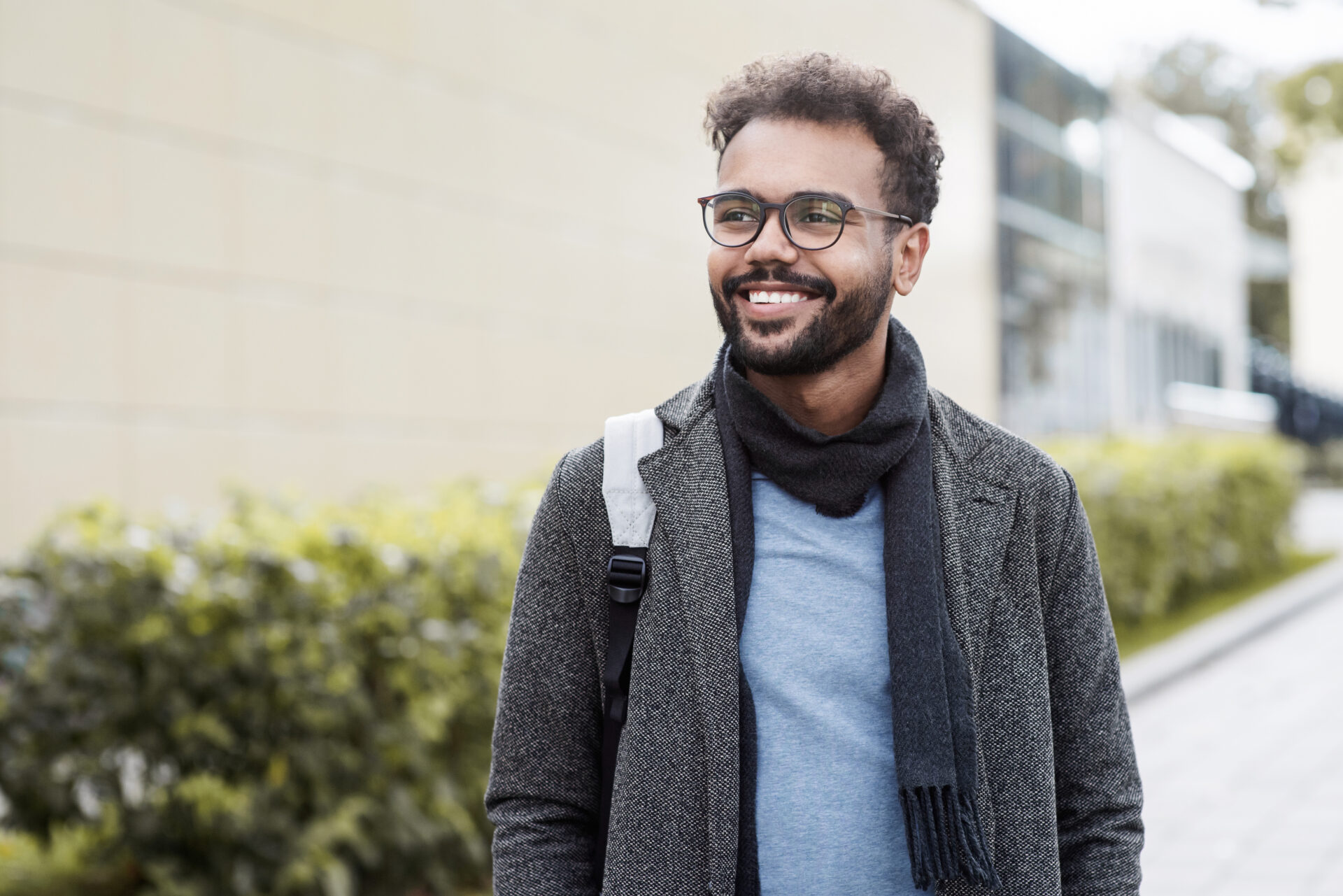 Handsome young man wearing warm clothing looking up