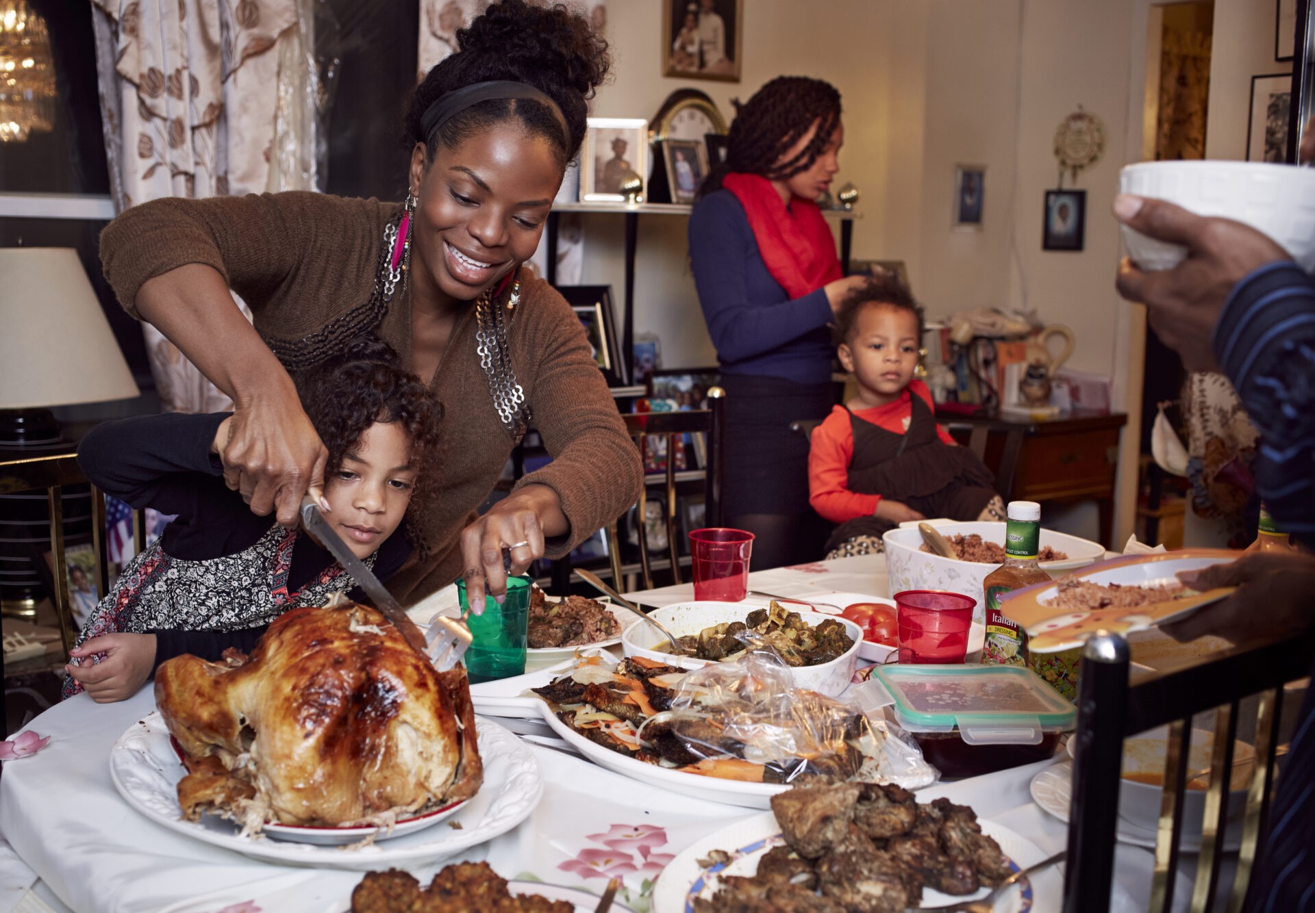 Mother and daughter carving turkey at holiday dinner