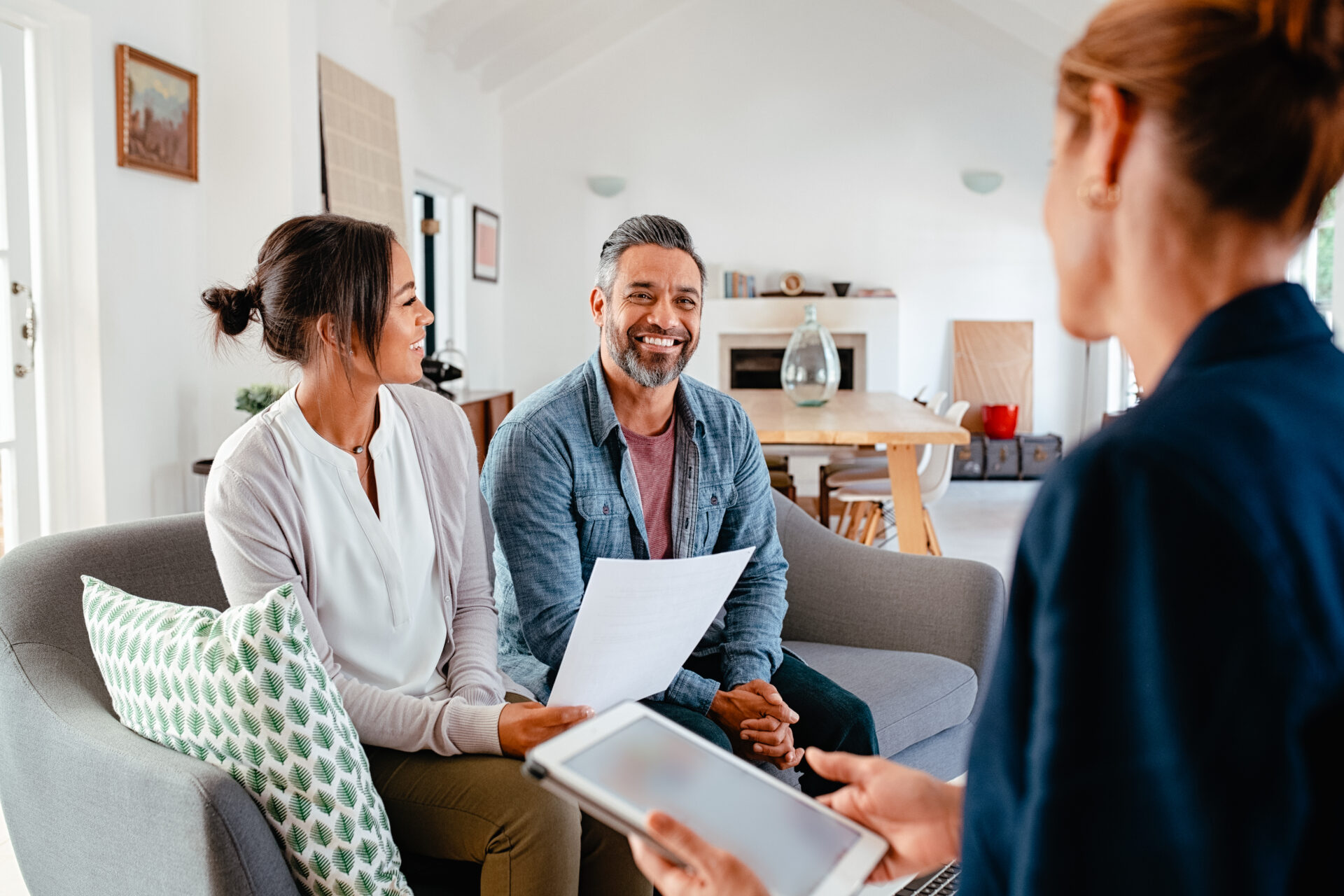 Couple talking to financial advisor at home