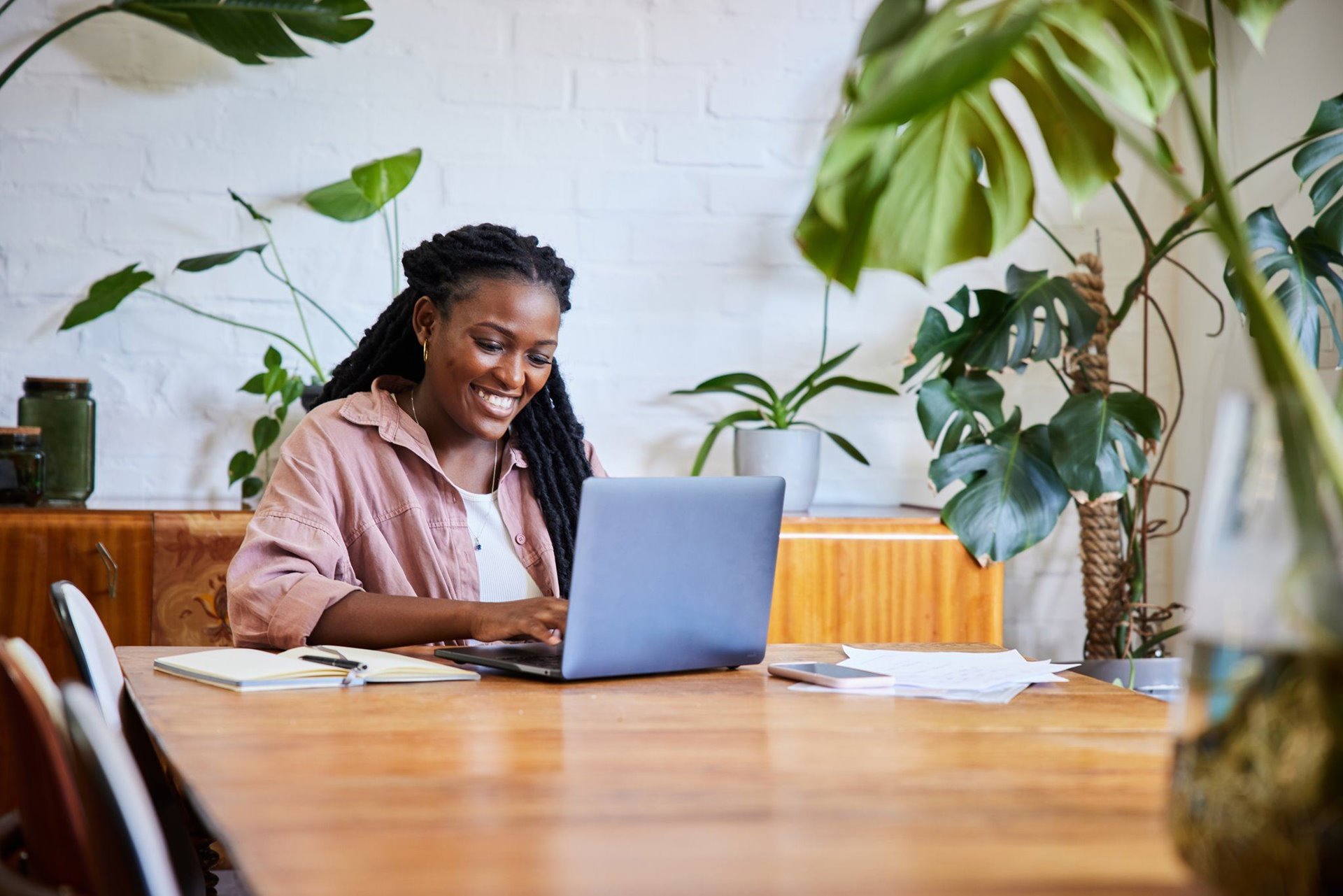 A woman sitting down touch her laptop