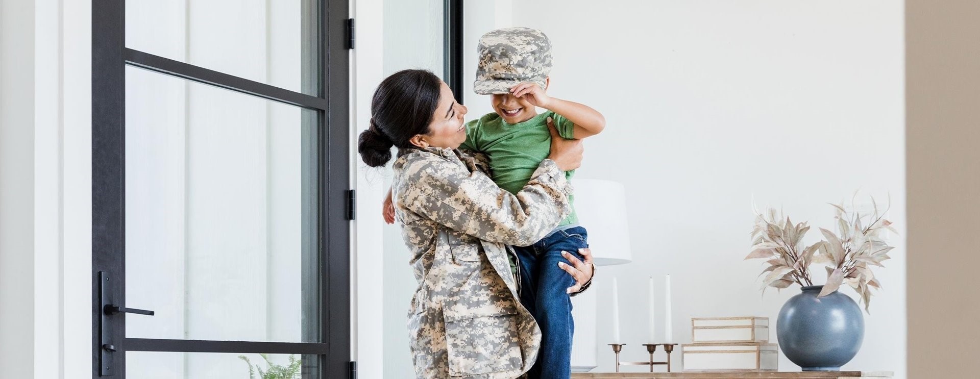 A woman in army suit and holding her son