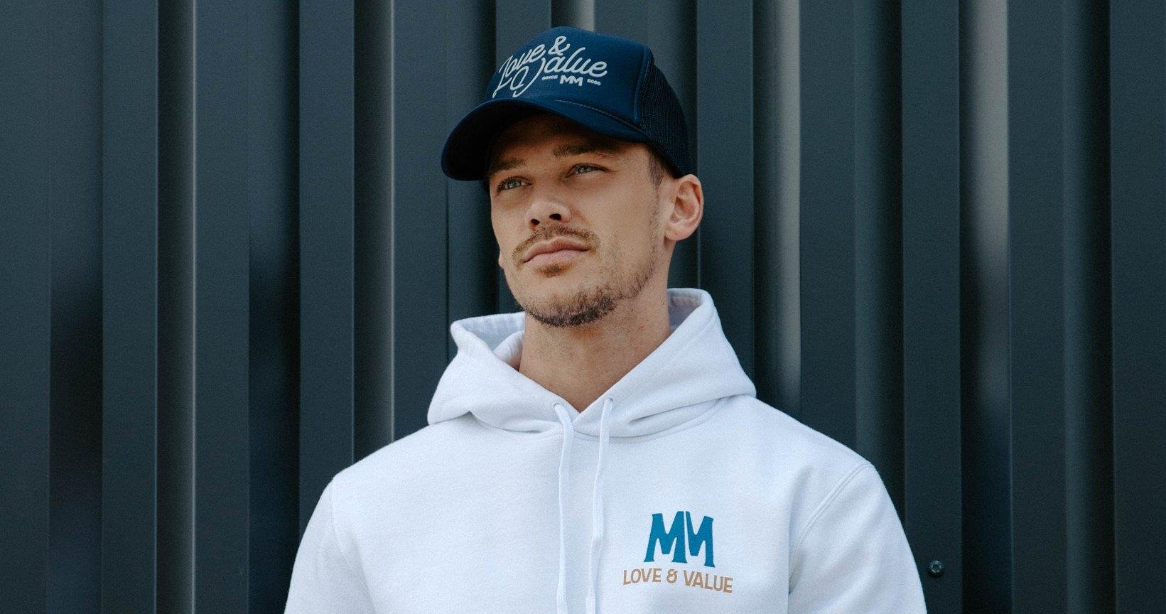 Man modeling Love & Value hoodie and hat